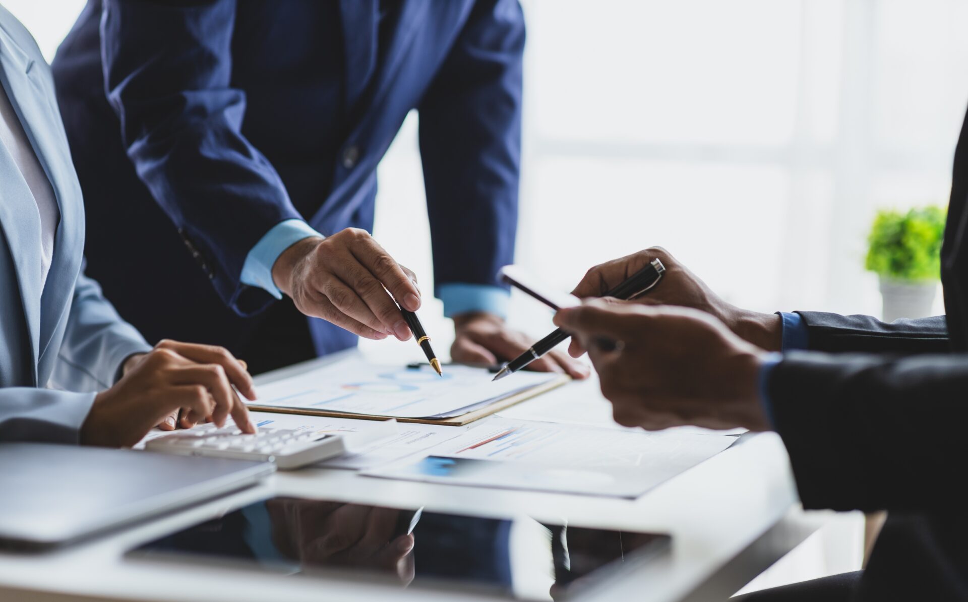 Businessmen in a meeting reviewing finances.